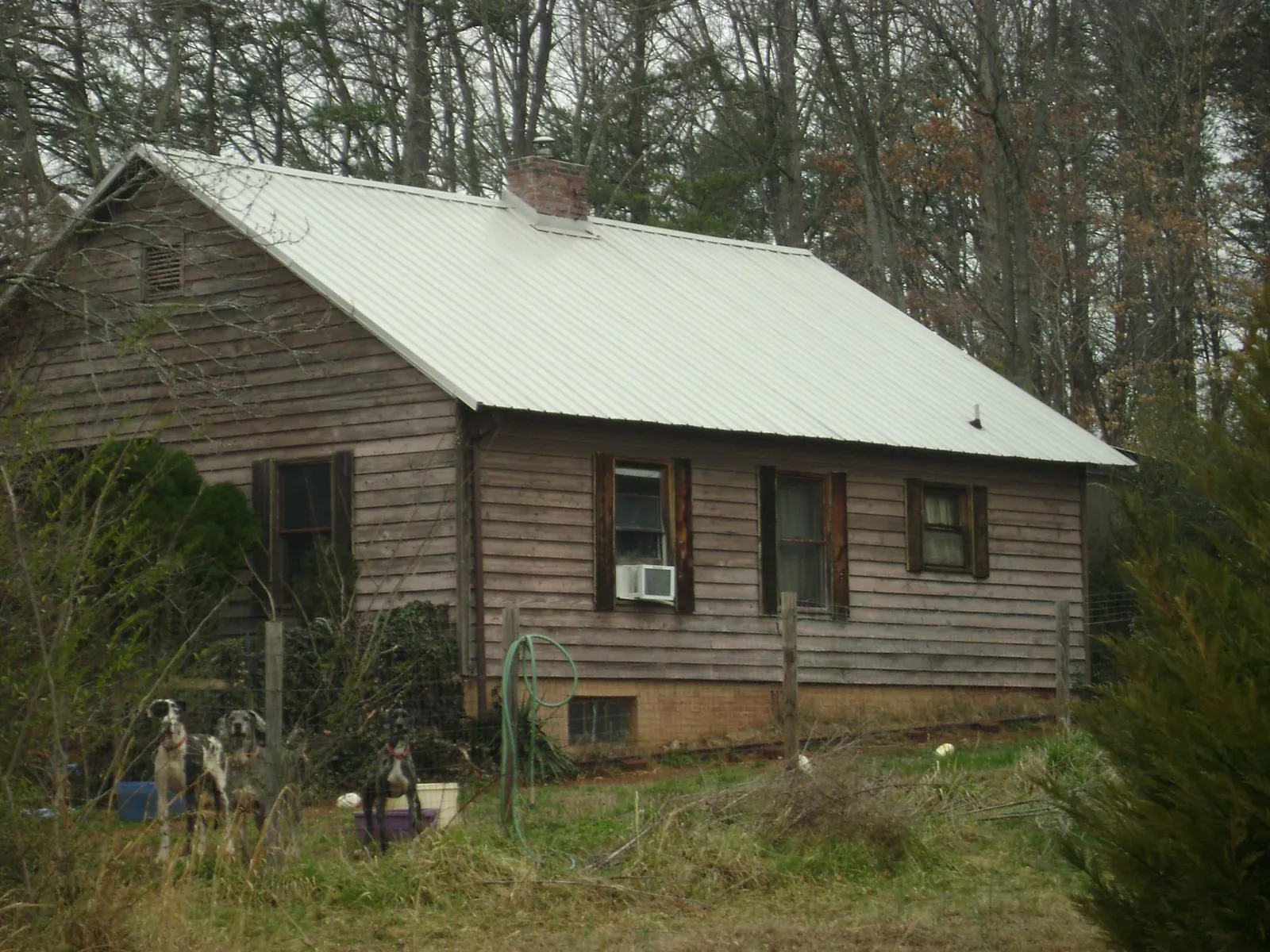 White metal roof on an old wood sided farmhouse, from a Asphalt Shingle Roof Repair job in Mountain Home